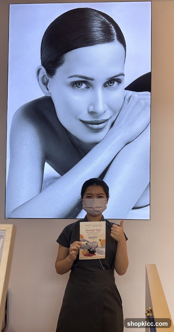 Woman holding a brochure in front of a large portrait
