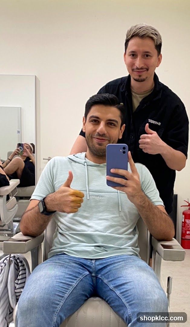 Two men giving thumbs up in a salon
