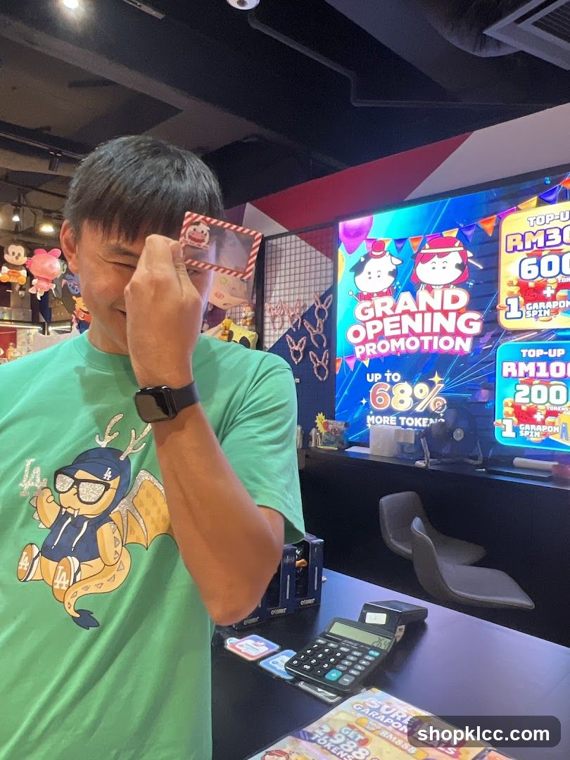 Man holding card near arcade screen