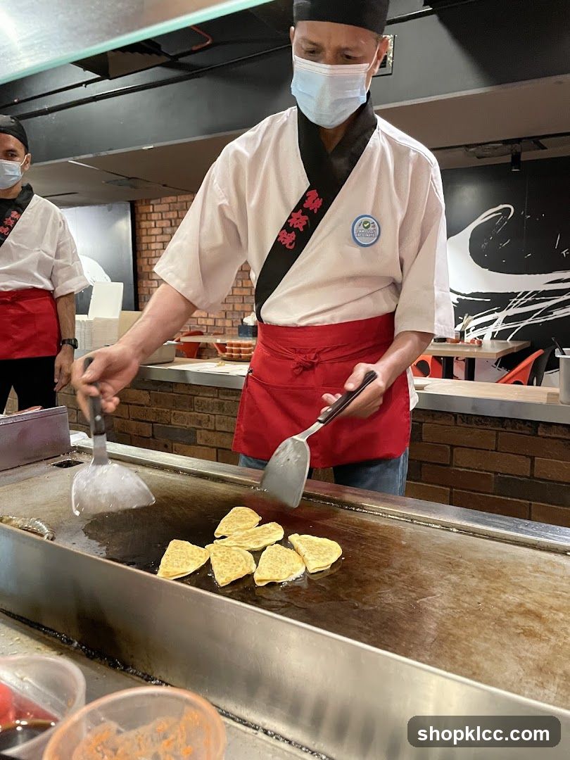 Chefs cooking on a teppanyaki grill
