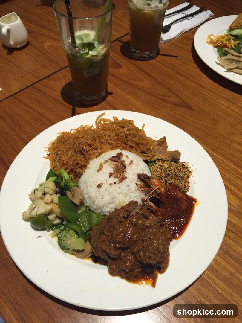 Plate of food with rice, meat, vegetables, and shrimp
