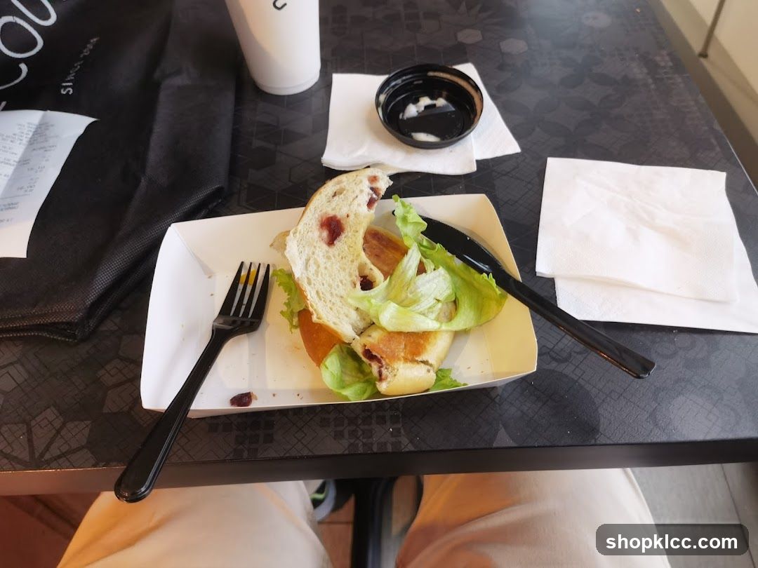 Half-eaten sandwich on a tray