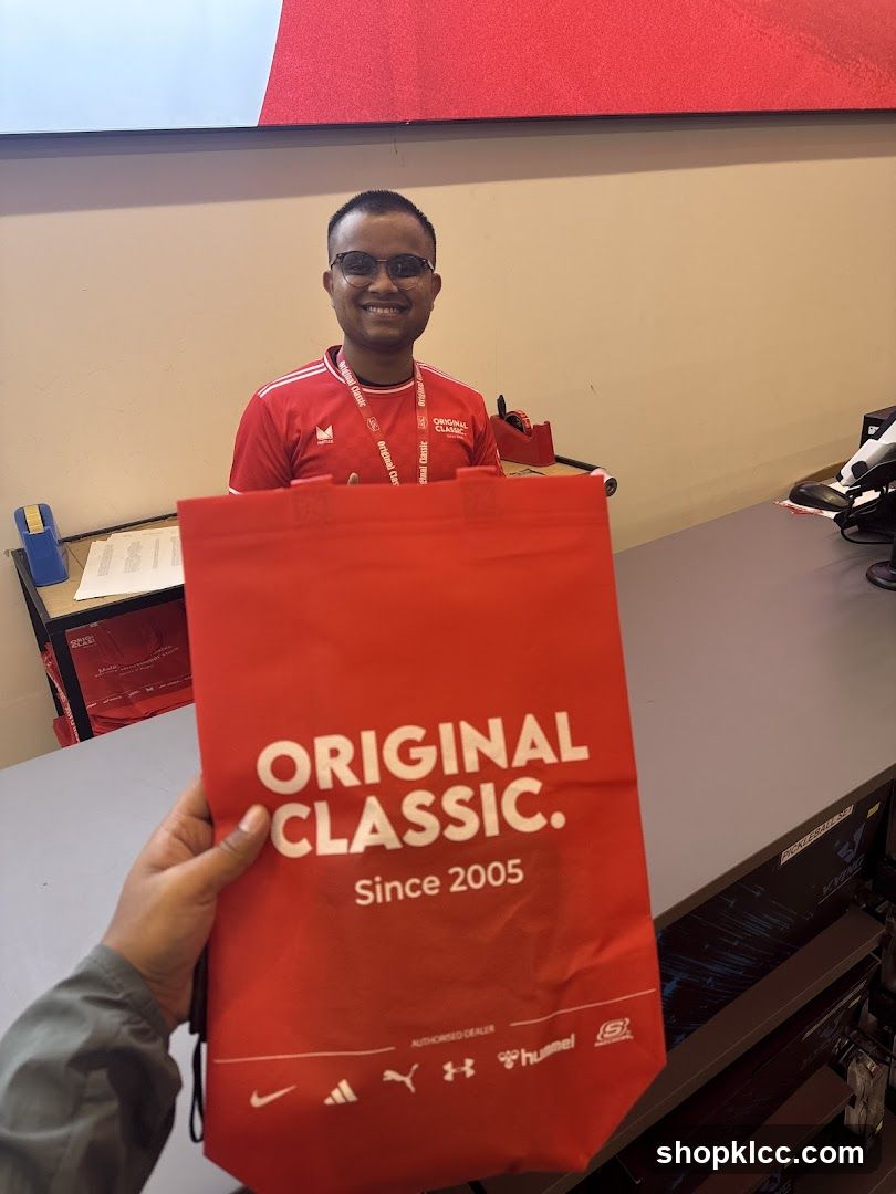 Man holding a branded bag