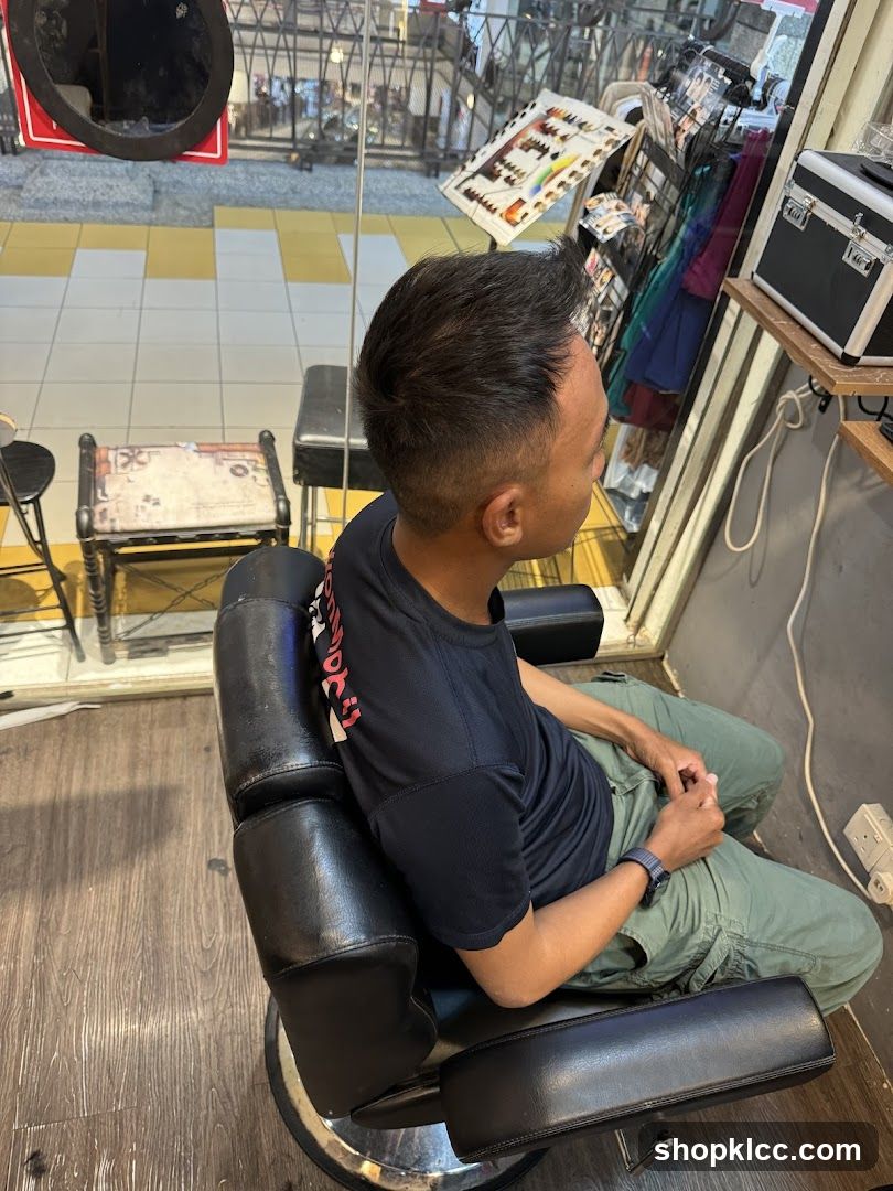 Man sitting in a barber chair