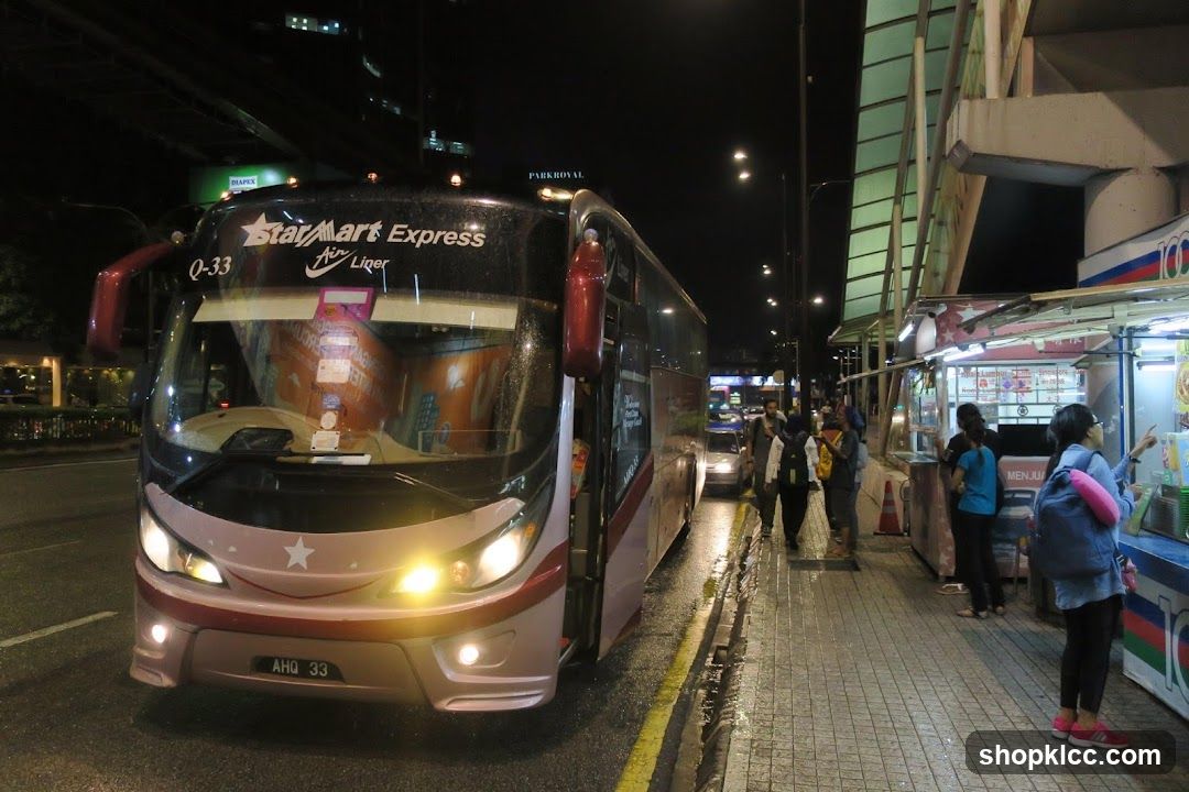 Night street scene with bus and food stall