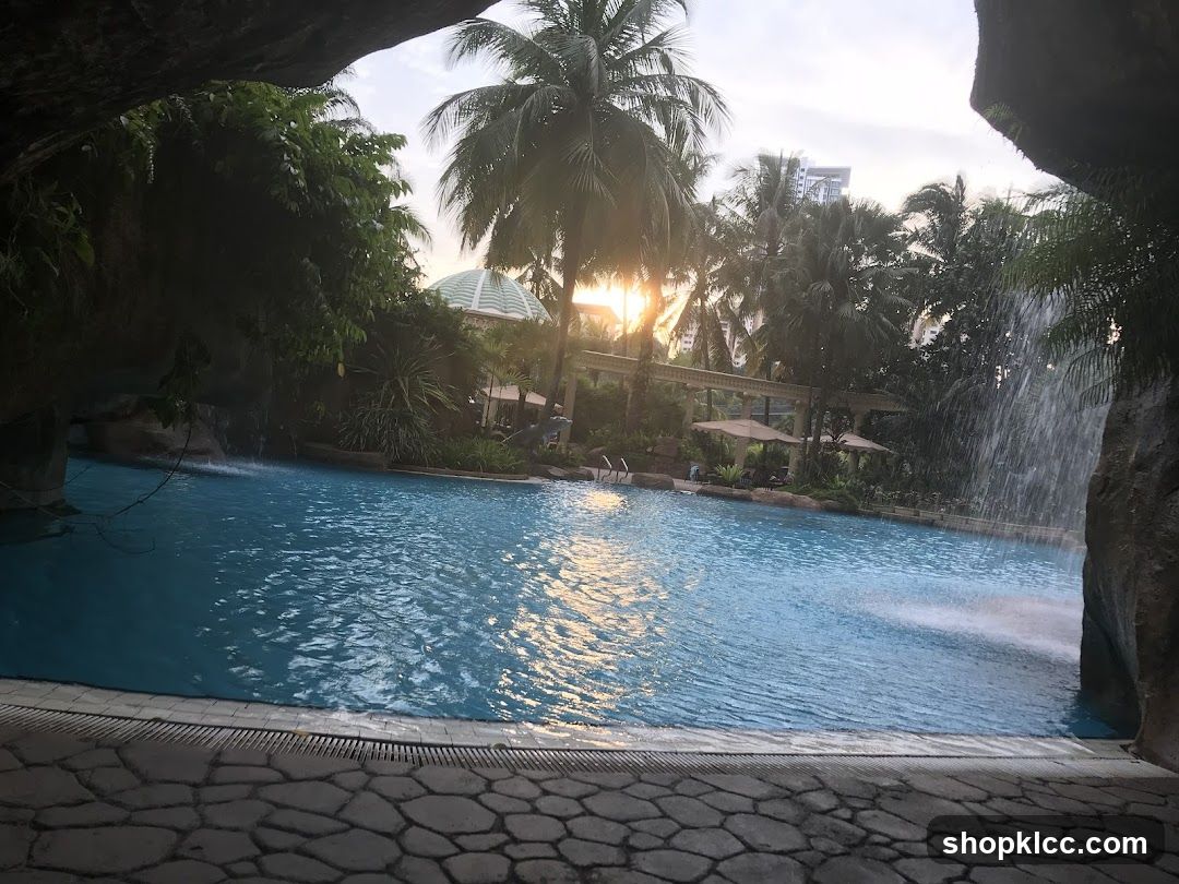 Resort Pool with Waterfall and Palm Trees