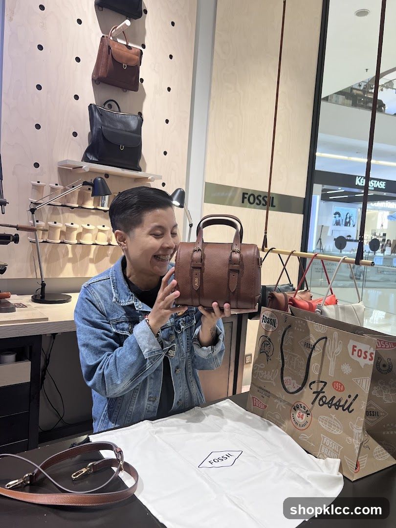 Woman holding a Fossil handbag