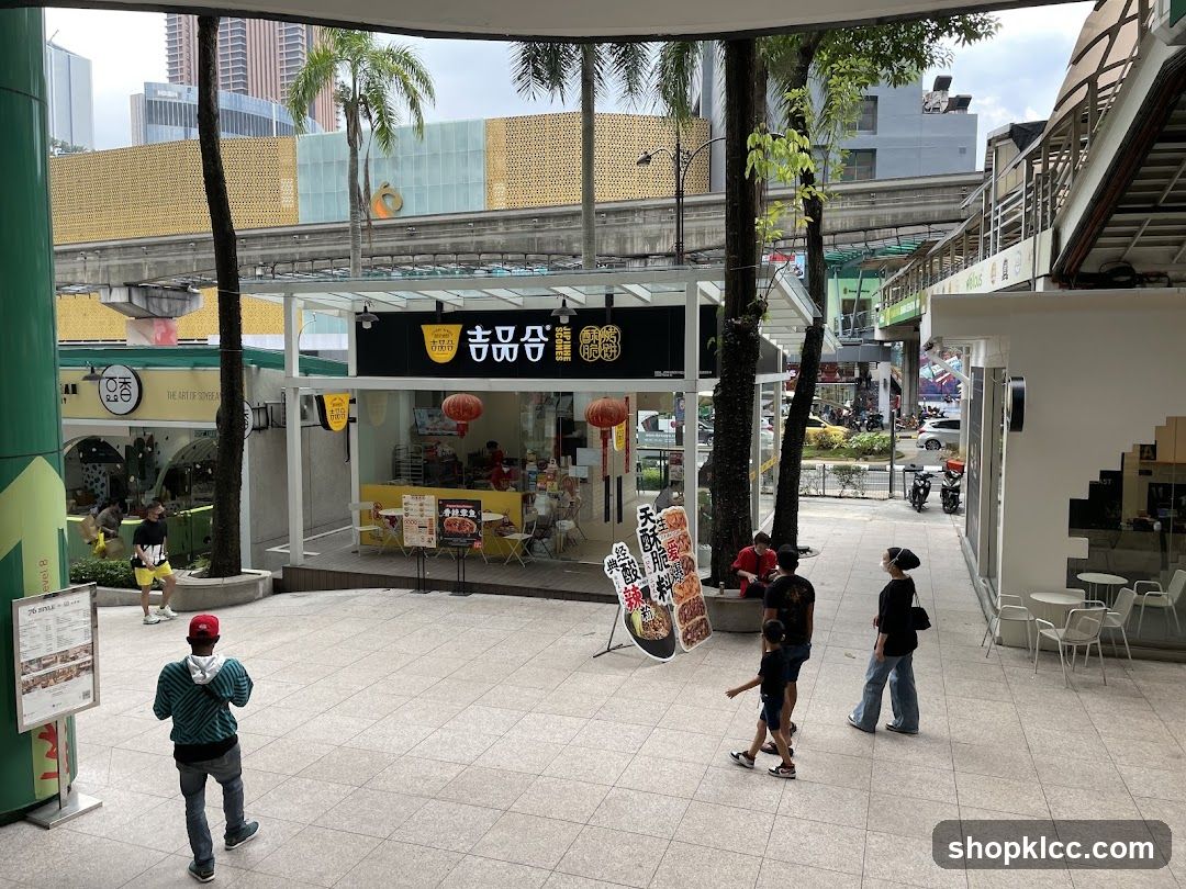 Outdoor Mall Scene with Food Stall and Pedestrians