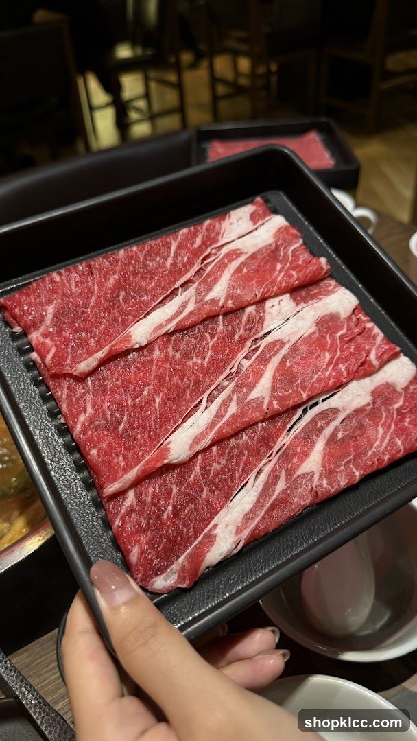 Raw Beef Slices on Black Tray