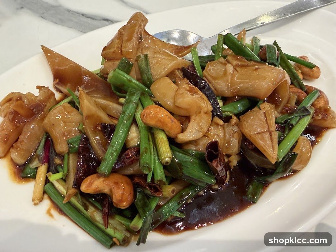 Stir-fried dish with squid, cashews, and scallions