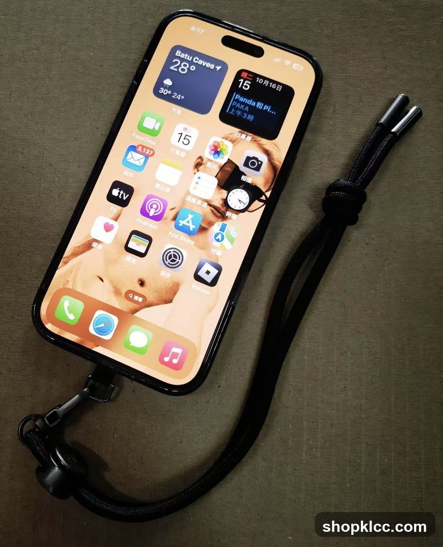 iPhone with wrist strap on surface