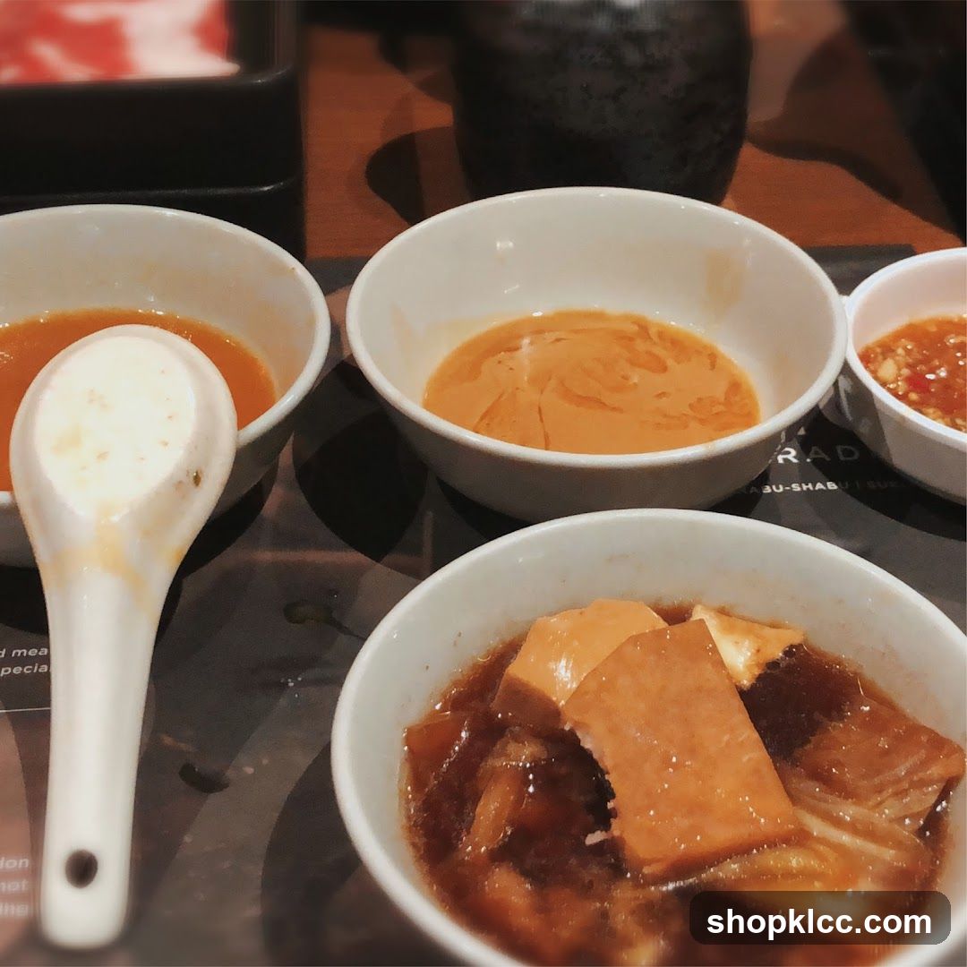 Dining Table with Bowls of Soup and Sauce