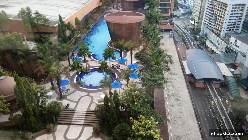 Aerial view of a resort pool area and adjacent highway