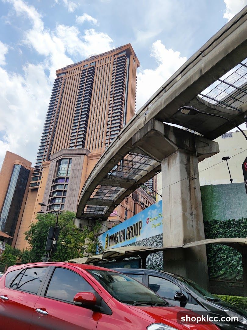 Urban street scene with elevated train track and high-rise building