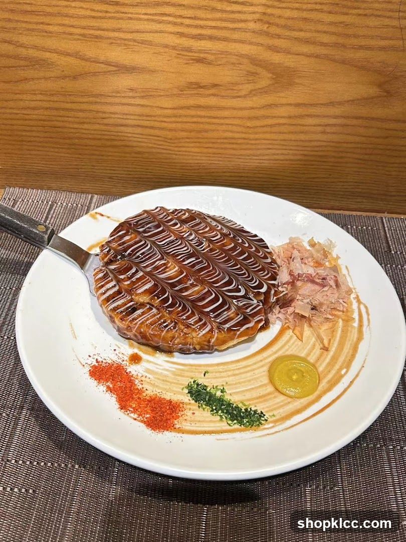 Okonomiyaki with toppings and sauces