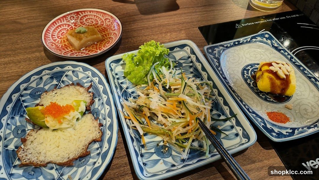 Japanese-style food spread on patterned plates