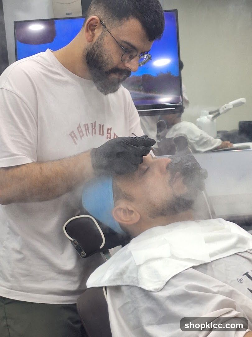 Barber performing facial treatment