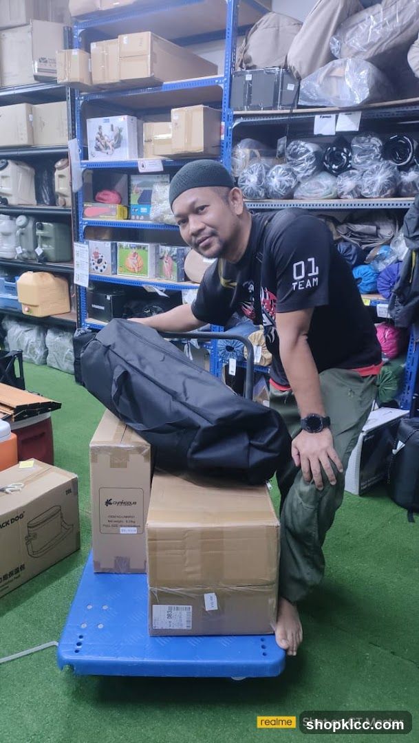 Man with boxes and bag on cart