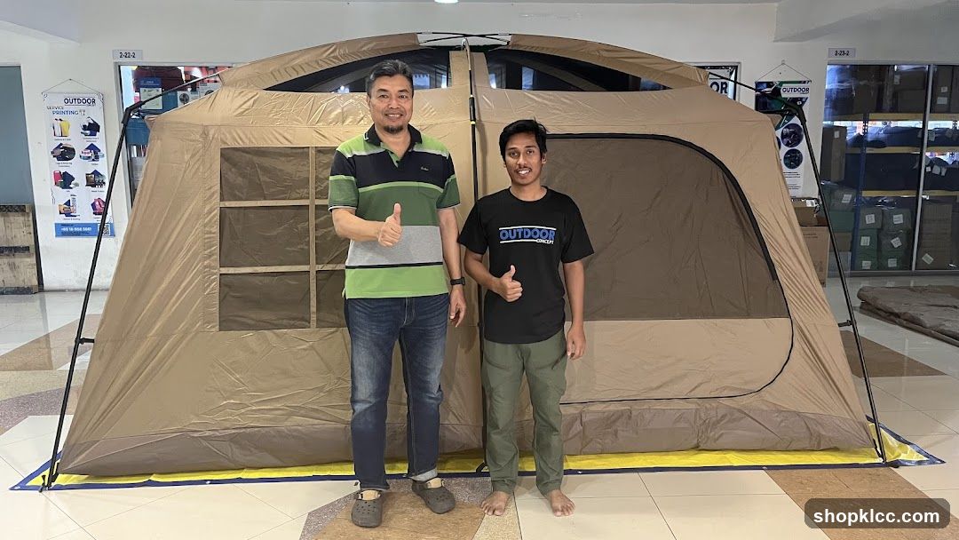 Two Men Posing in Front of a Large Tent
