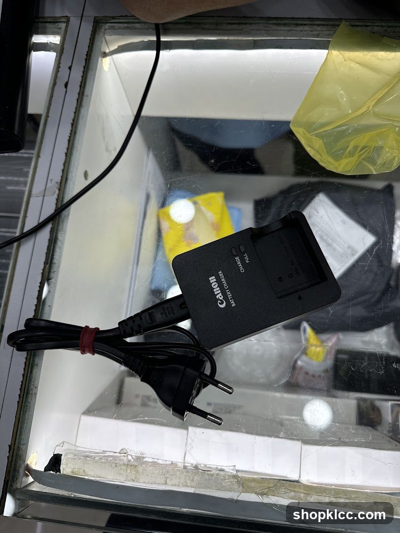 Canon Battery Charger on Glass Display Case