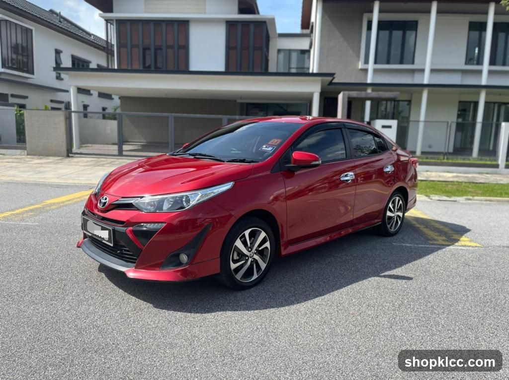 Red Toyota Yaris parked in residential area