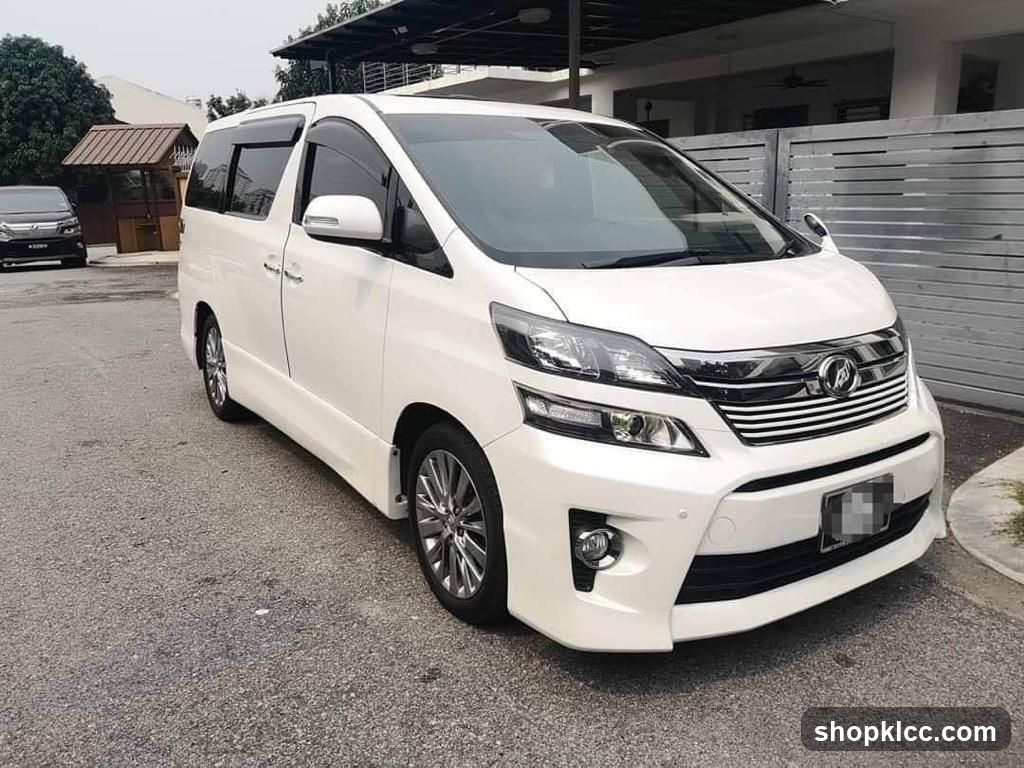 White Toyota Alphard parked outside a house