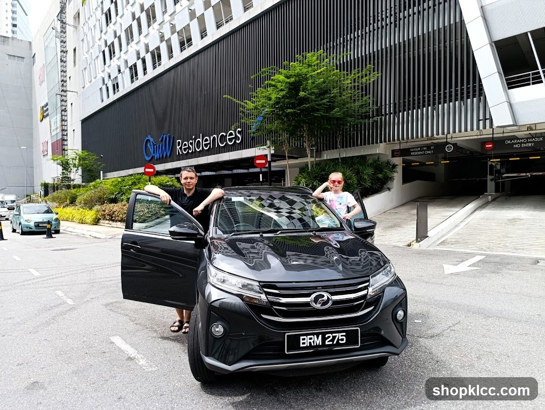 Car in front of building with signage