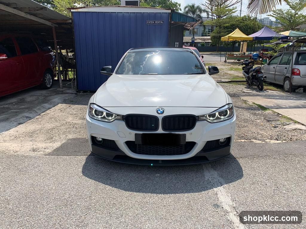 White BMW parked in lot