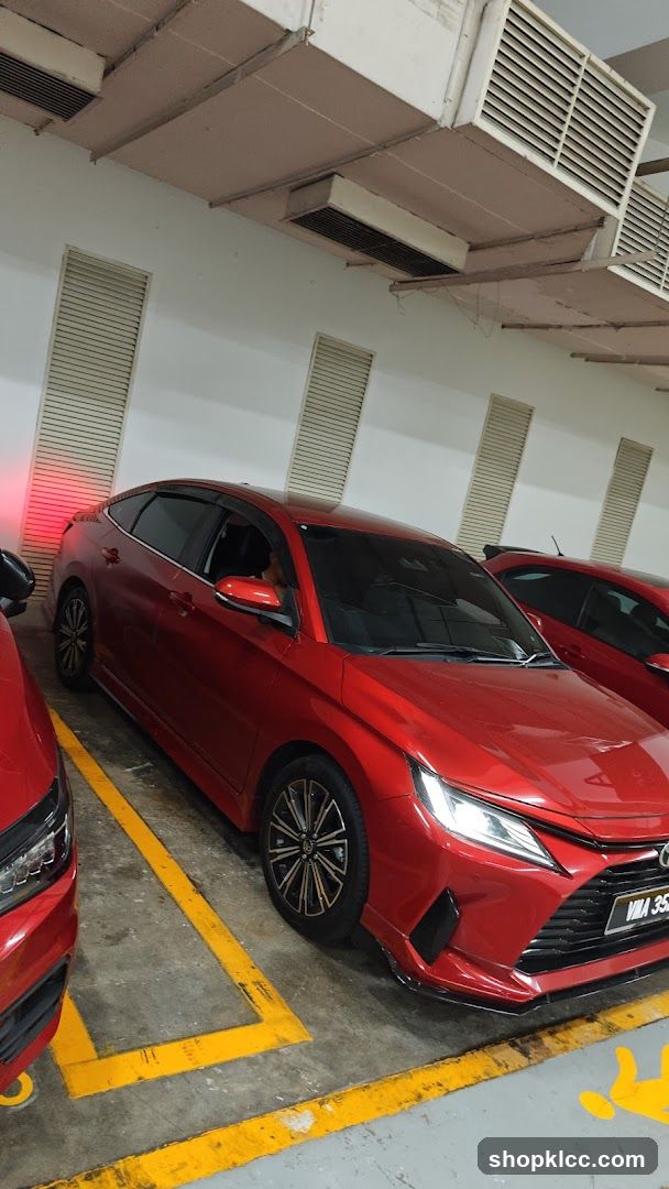 Red Sedan in Parking Garage