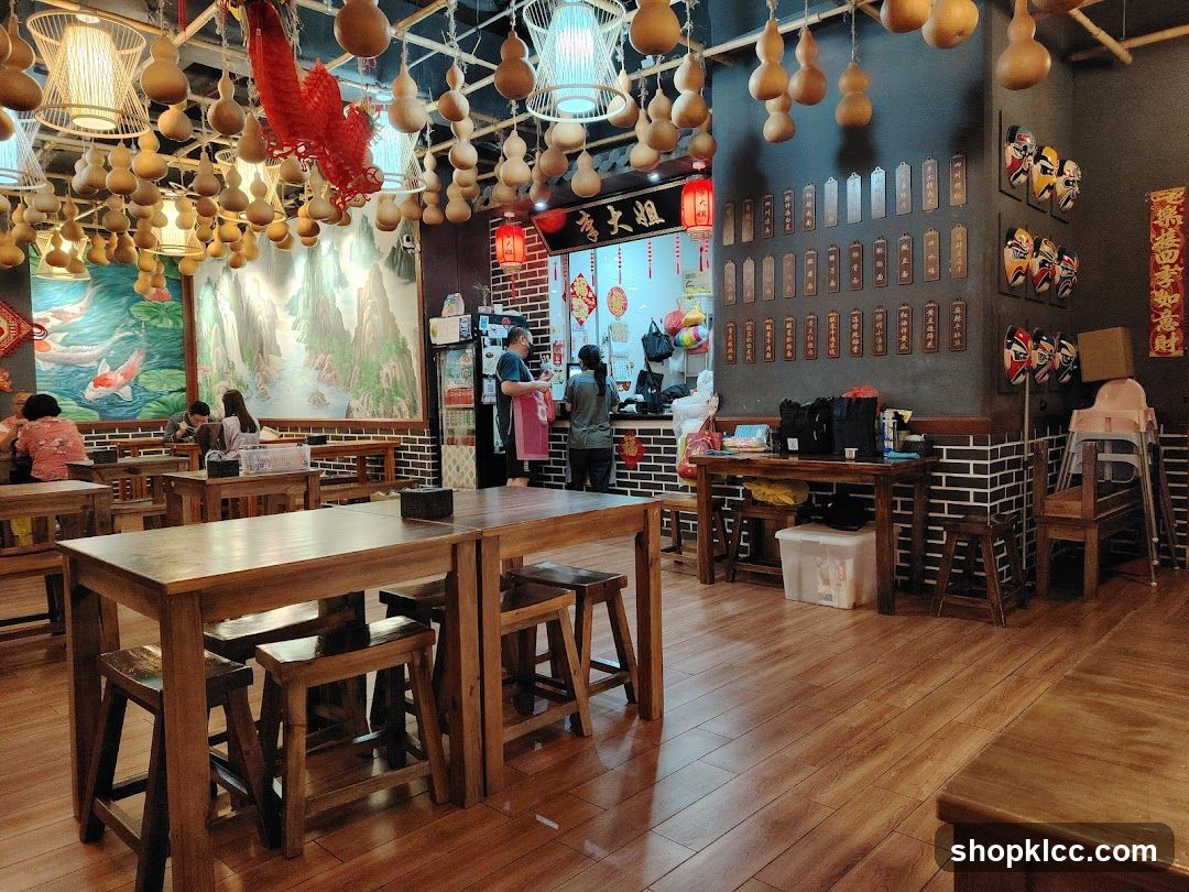 Interior of a Chinese-style restaurant with hanging gourd decorations and wooden furniture.