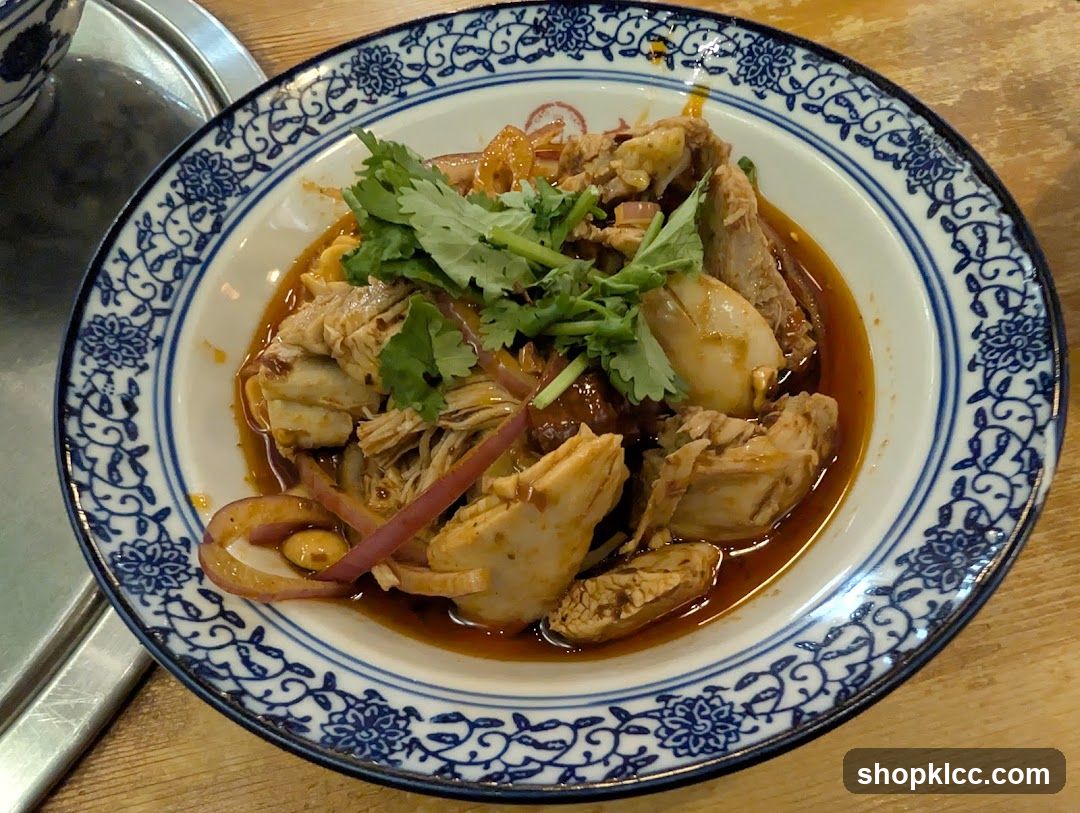 Bowl of Spicy Chicken with Cilantro and Onions