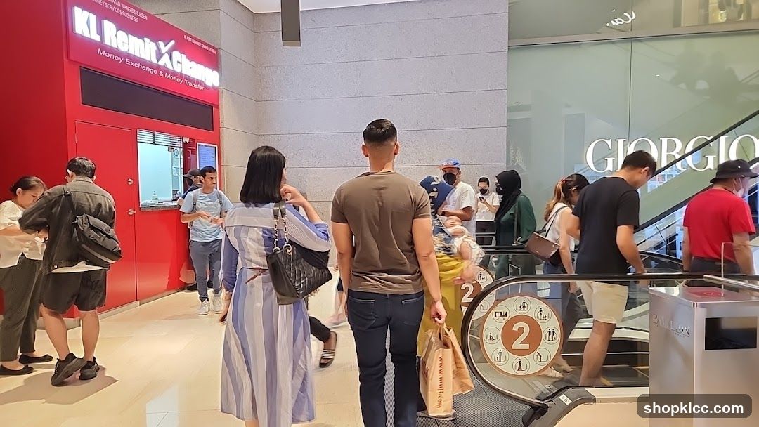 People at a Money Exchange and Escalator