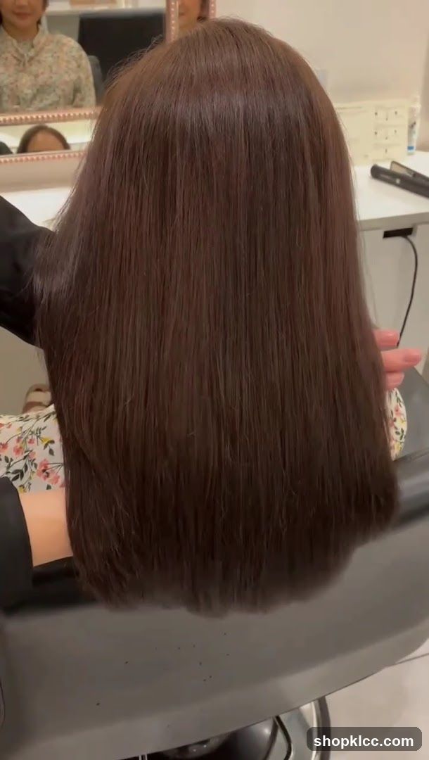 Hairdresser styling long brown hair