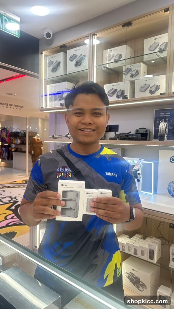 Person holding product boxes in store