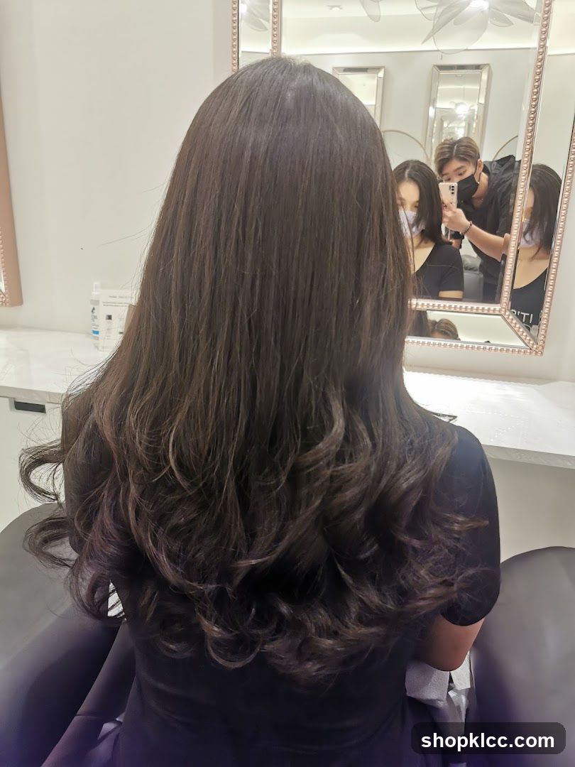 Hairdresser styling client's hair