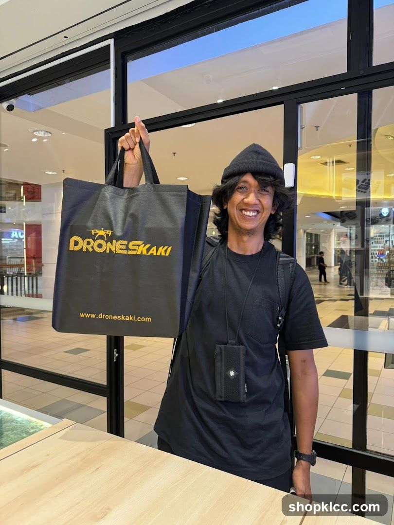 Person holding branded tote bag