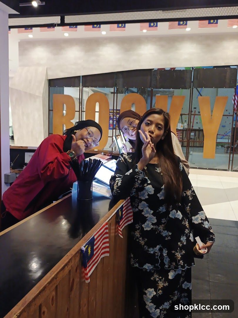 Three women posing at a counter