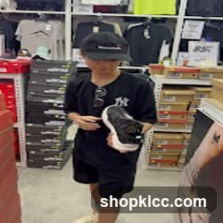 Person holding shoes in store
