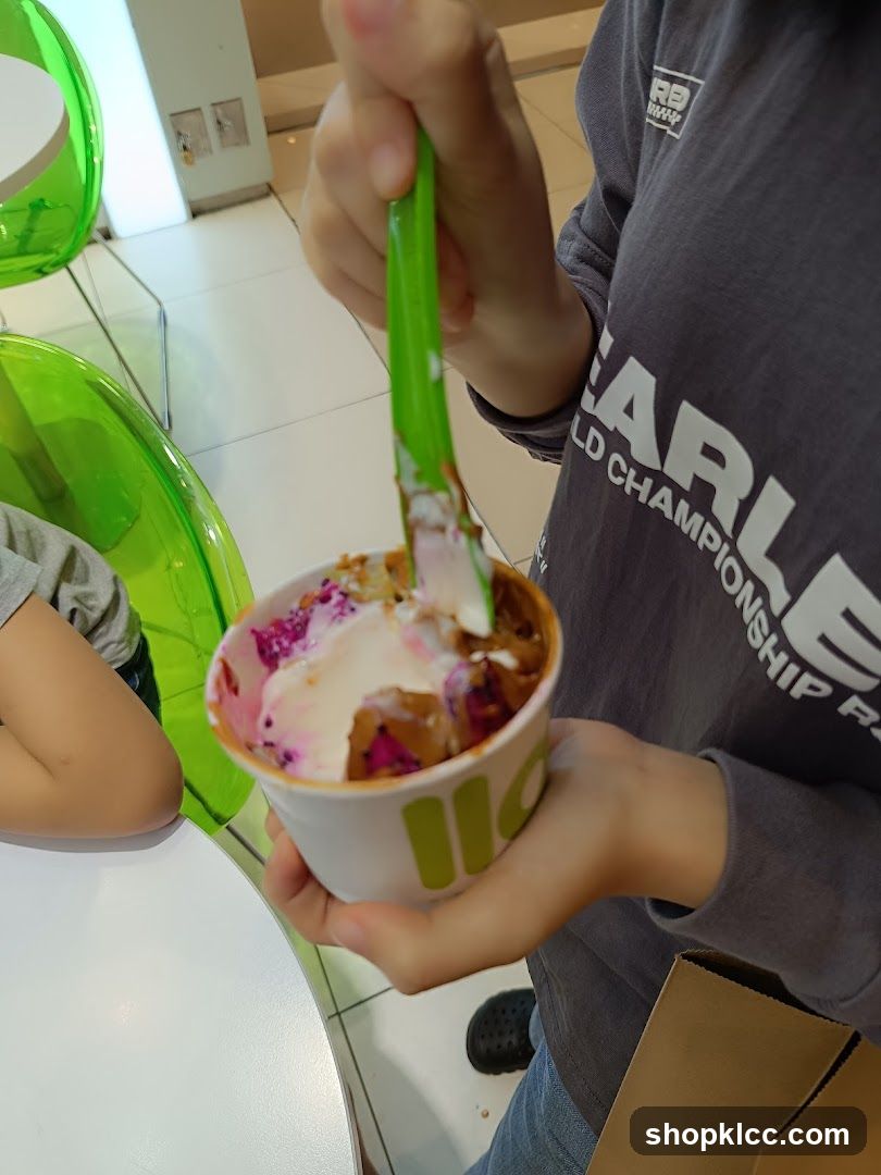 Person holding a cup of frozen yogurt