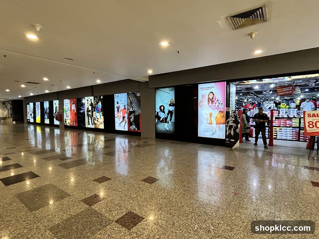 Shopping Mall Corridor with Storefronts and Advertisements