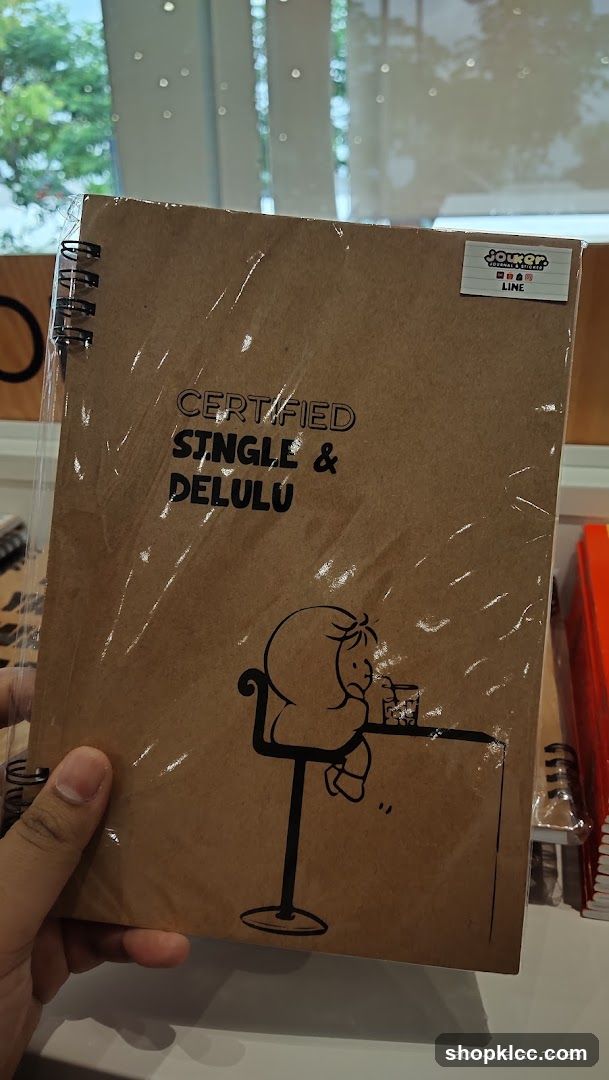 Notebook with "Certified Single & Delulu" text