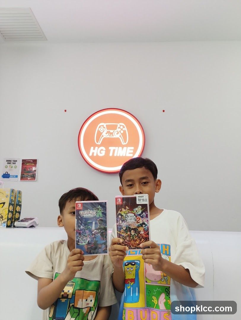 Two boys holding video games