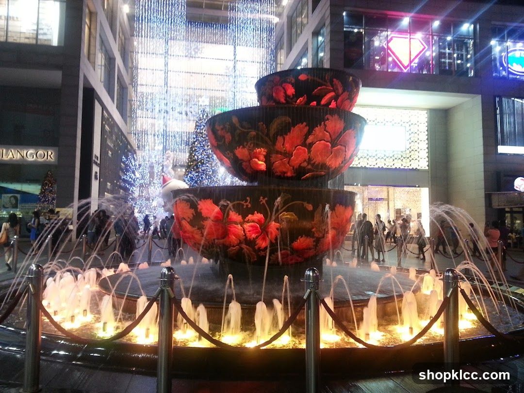 Fountain with illuminated bowls and water jets at night