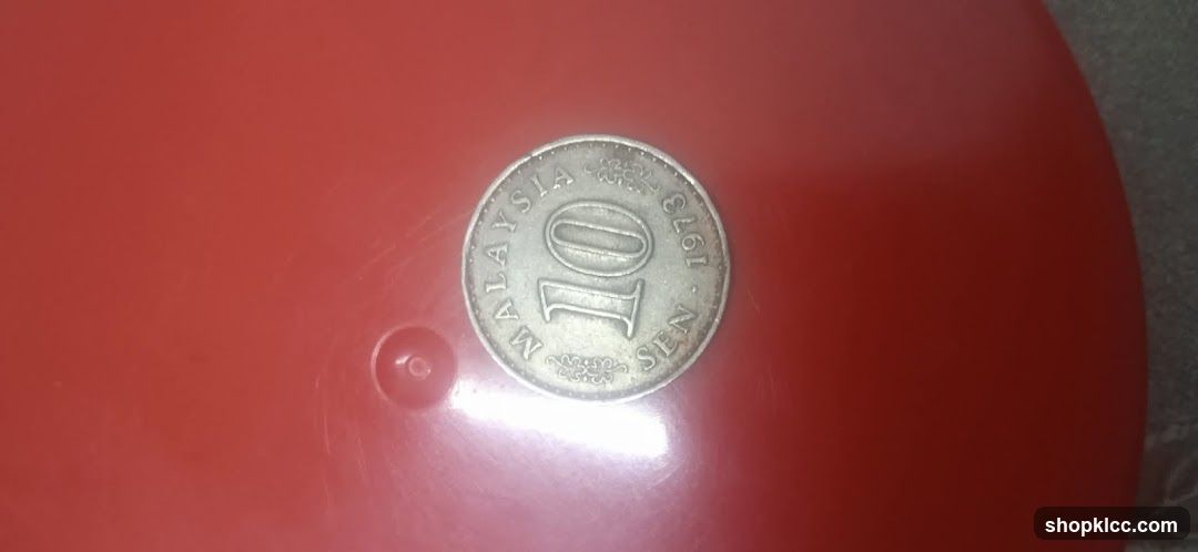 10 Sen Coin on Red Surface
