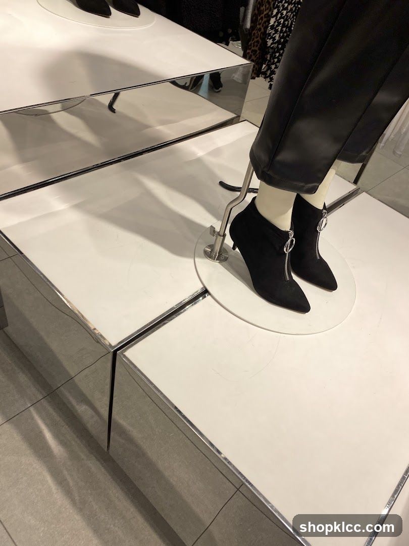 Mannequin wearing black boots and pants