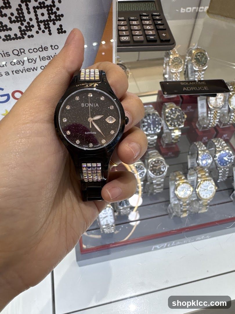 Person holding a watch in a store