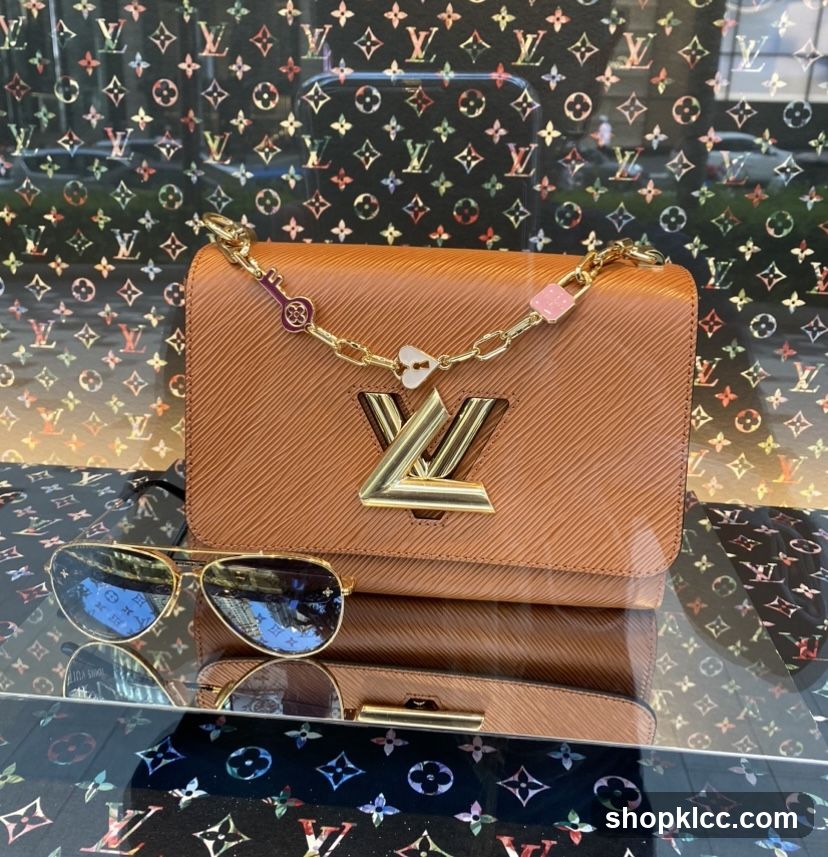 Brown handbag with gold chain and sunglasses