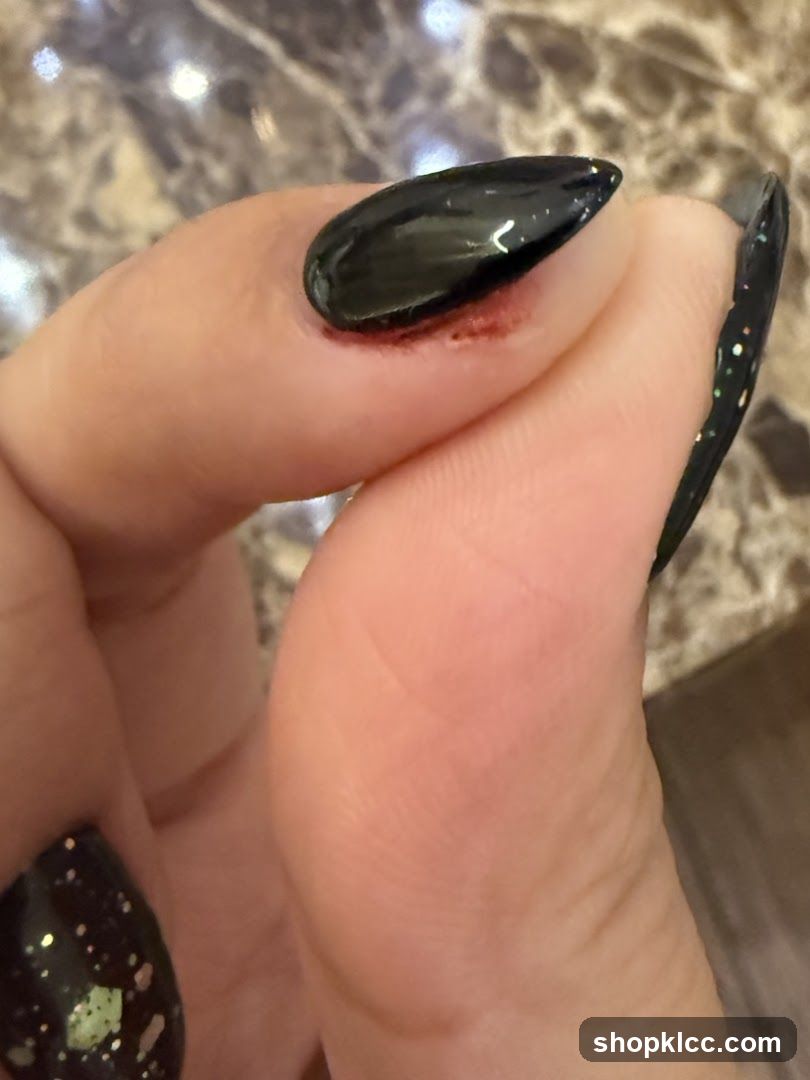 Close-up of a person's hand with black nail polish