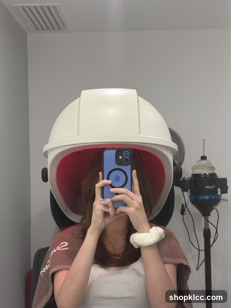 Woman under hair steamer