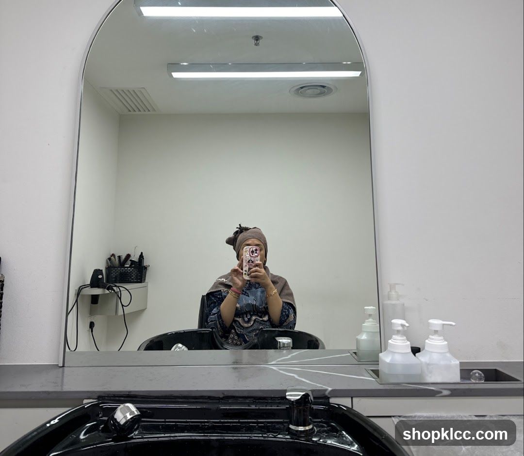 Woman taking a selfie in a salon mirror